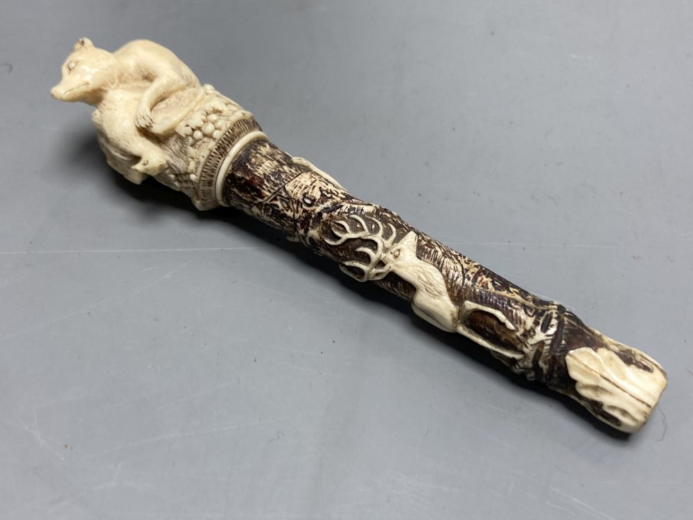 A Dieppe carved ivory pipe tamper, length 11cm